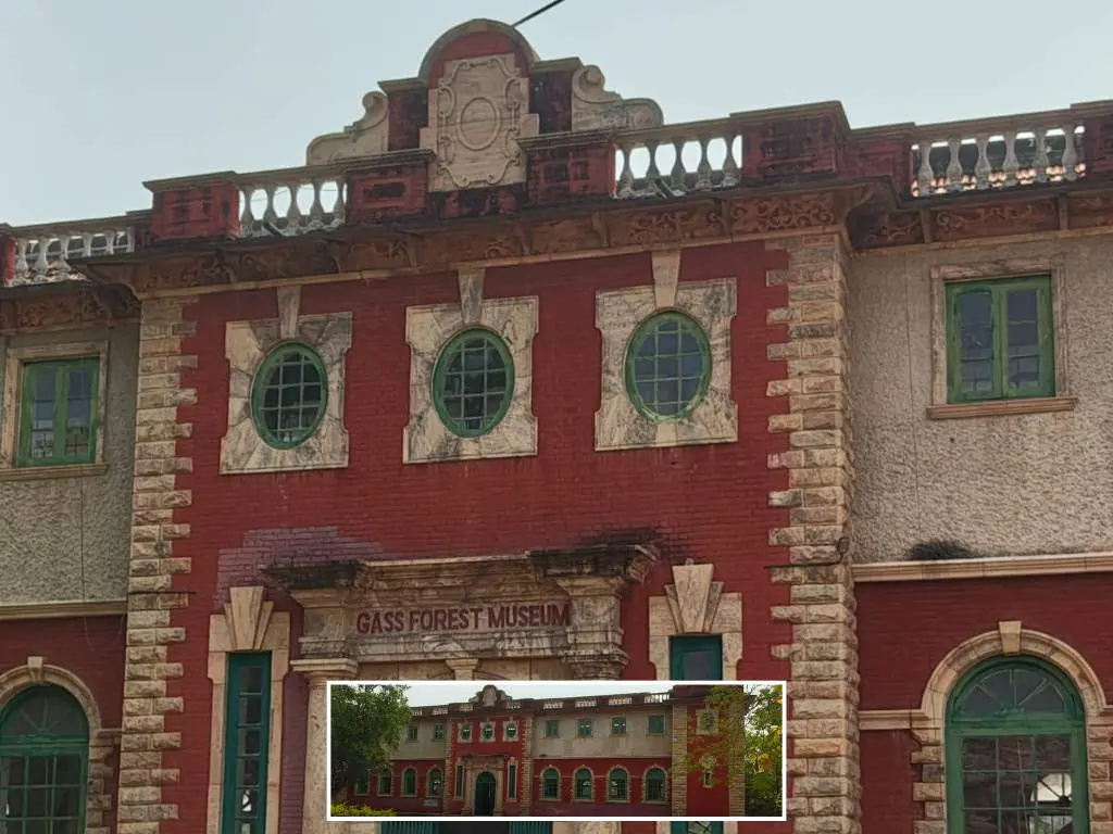 Red and beige stone exterior of the historic Gass Forest Museum building with a sign over the main entrance