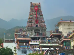 Front view of Marudhamalai Arulmigu Subramaniyaswami Temple gopuram in Coimbatore, dedicated to Lord Murugan, set against the Western Ghats