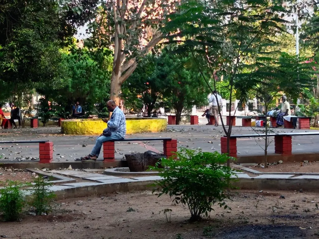 People relaxing at seating area inside VOC Park Coimbatore